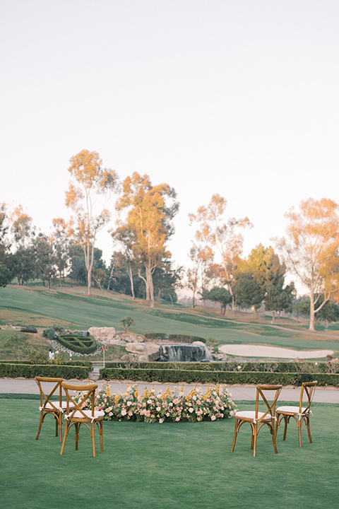  a neutral romantic wedding with touches of peach colors and the groom in a tan suit- ceremony 