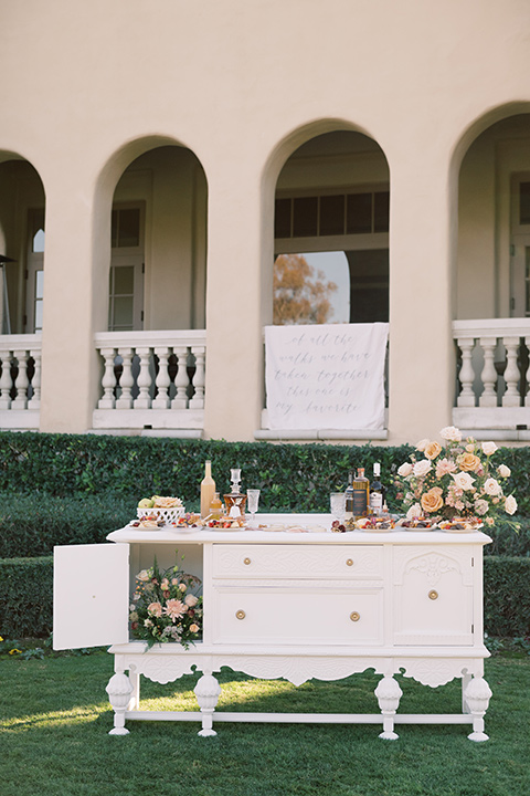  a neutral romantic wedding with touches of peach colors and the groom in a tan suit- cookies 