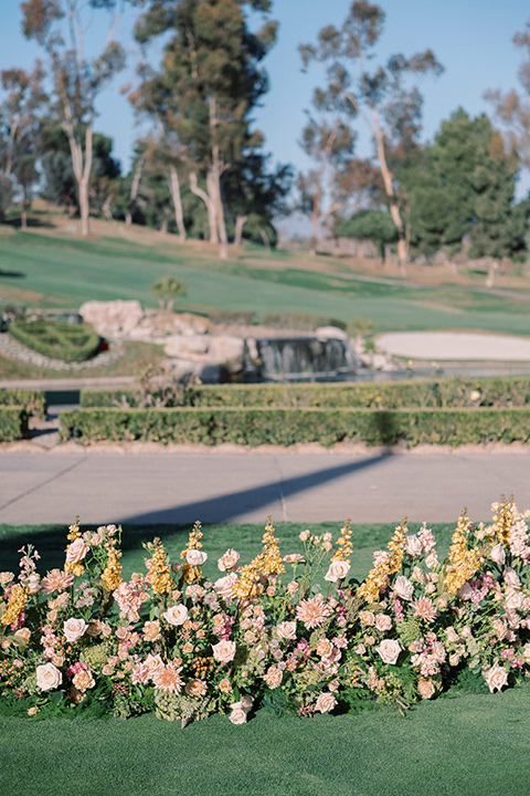  a neutral romantic wedding with touches of peach colors and the groom in a tan suit- bride 