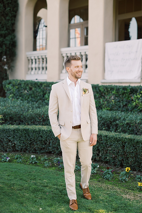  a neutral romantic wedding with touches of peach colors and the groom in a tan suit- bride 