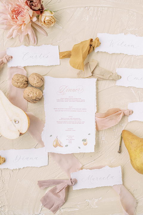 a neutral romantic wedding with touches of peach colors and the groom in a tan suit- invites 