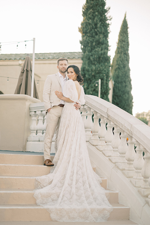  a neutral romantic wedding with touches of peach colors and the groom in a tan suit- invites 