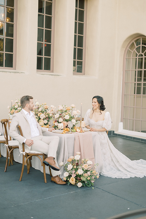  a neutral romantic wedding with touches of peach colors and the groom in a tan suit- bride 