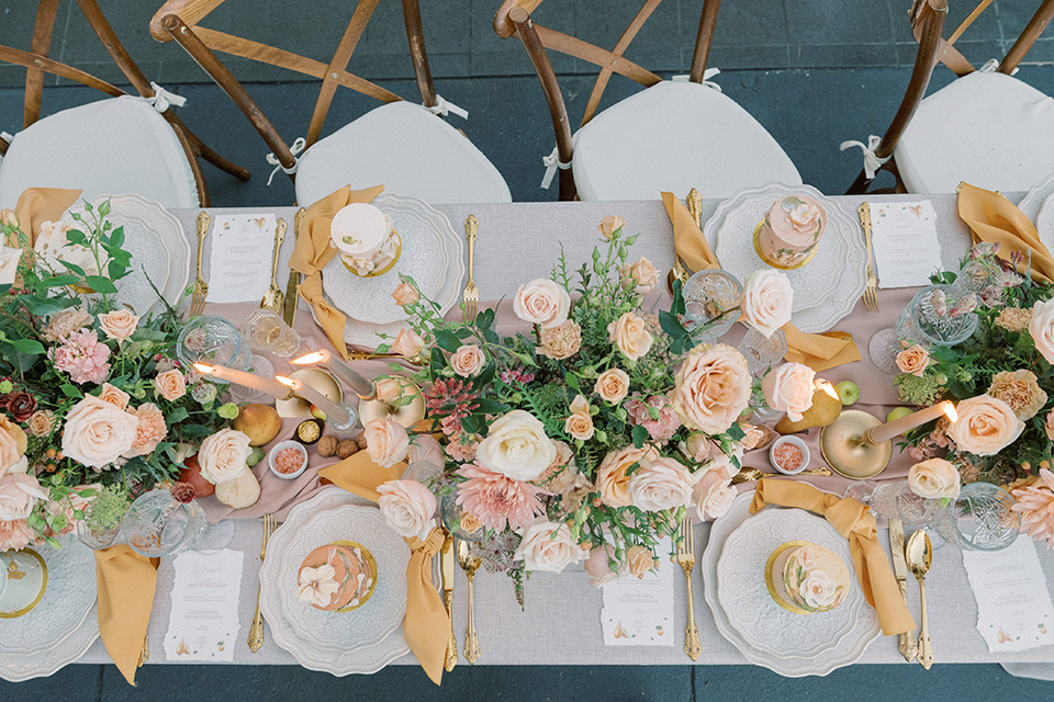  a neutral romantic wedding with touches of peach colors and the groom in a tan suit 