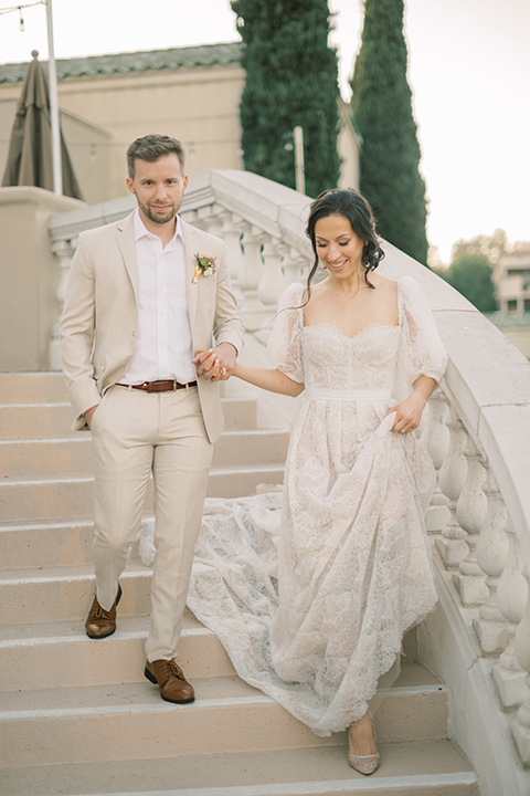  a neutral romantic wedding with touches of peach colors and the groom in a tan suit- bride 