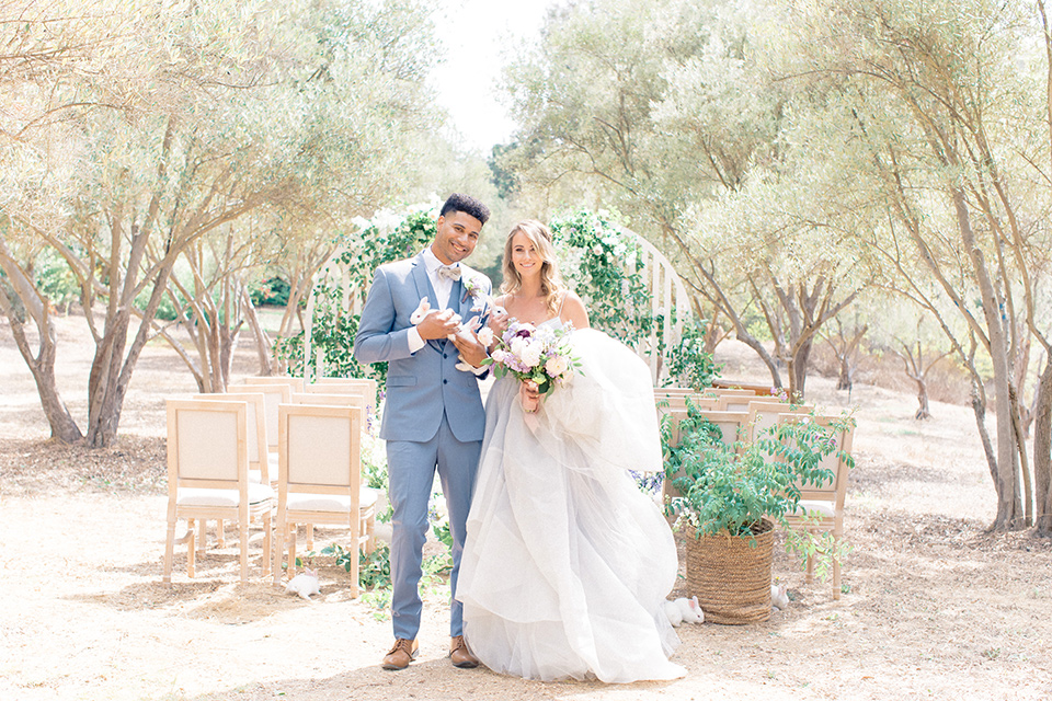  Perfectly Provincial Wedding with baby animals and the bride in a ballgown and the groom in a light blue suit 