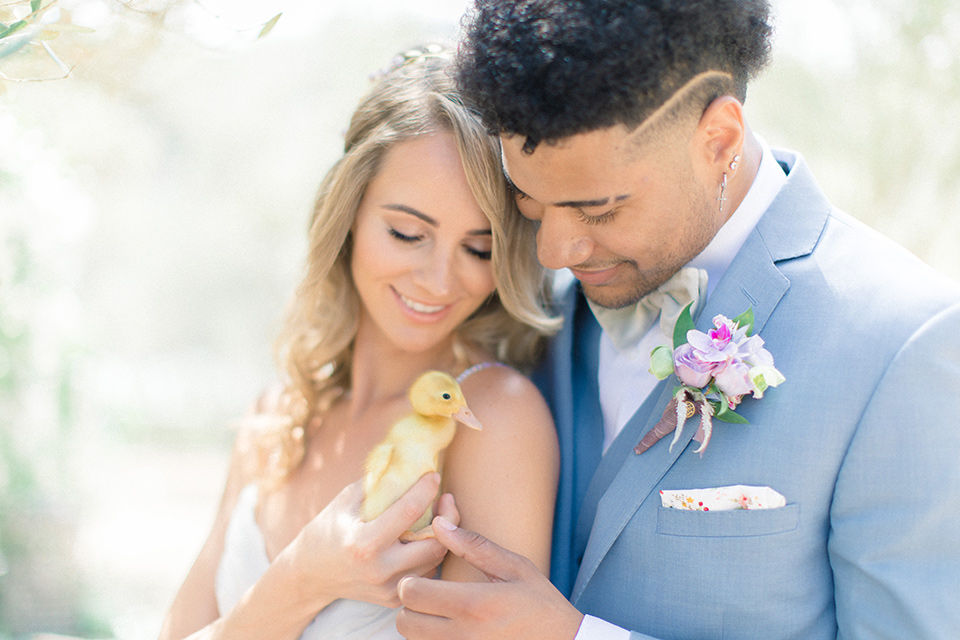  Perfectly Provincial Wedding with baby animals and the bride in a ballgown and the groom in a light blue suit 