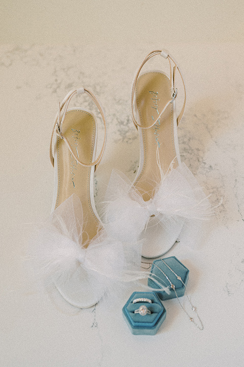 a wedding at the grand gimeno with white, blue, and gold accents – the bride wore a long sleeved modern fitted gown and the groom wore a light blue suit with velvet bow tie – bridal shoes and rings