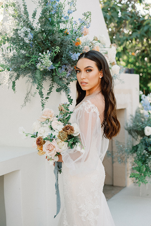 a wedding at the grand gimeno with white, blue, and gold accents – the bride wore a long sleeved modern fitted gown and the groom wore a light blue suit with velvet bow tie – bride in her bridal gown 