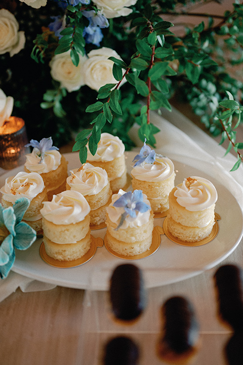 a wedding at the grand gimeno with white, blue, and gold accents – the bride wore a long sleeved modern fitted gown and the groom wore a light blue suit with velvet bow tie – macaroons and cookies 