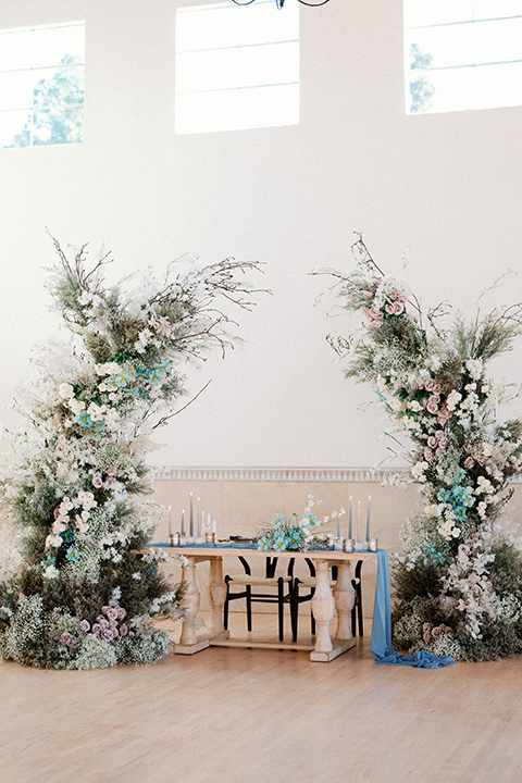 a wedding at the grand gimeno with white, blue, and gold accents – the bride wore a long sleeved modern fitted gown and the groom wore a light blue suit with velvet bow tie – reception décor
