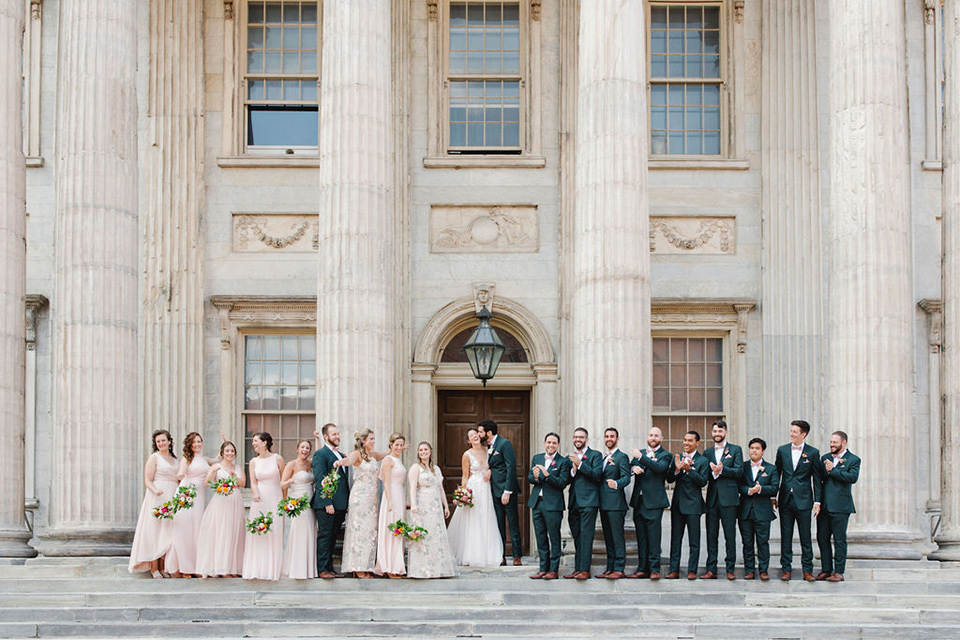  a downtown wedding at the cultural center with the groom and groomsmen in green suits and the bridesmaids in blush dresses and the bride in an a-line gown- bridal party in a line