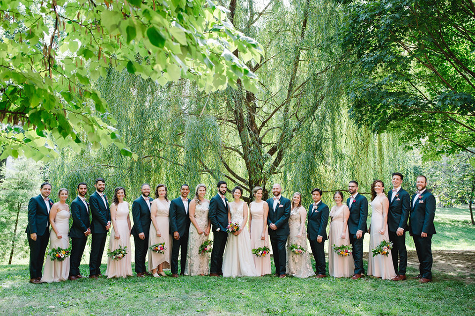  a downtown wedding at the cultural center with the groom and groomsmen in green suits and the bridesmaids in blush dresses and the bride in an a-line gown- bridal party in a line