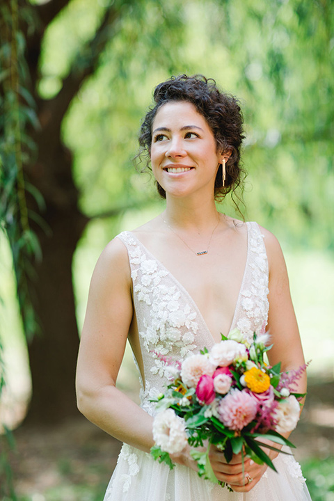  a downtown wedding at the cultural center with the groom and groomsmen in green suits and the bridesmaids in blush dresses and the bride in an a-line gown- bride close up 