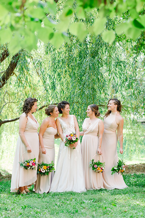  a downtown wedding at the cultural center with the groom and groomsmen in green suits and the bridesmaids in blush dresses and the bride in an a-line gown- bride and her bridesmaids 