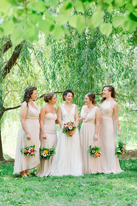  a downtown wedding at the cultural center with the groom and groomsmen in green suits and the bridesmaids in blush dresses and the bride in an a-line gown- bride and her bridesmaids