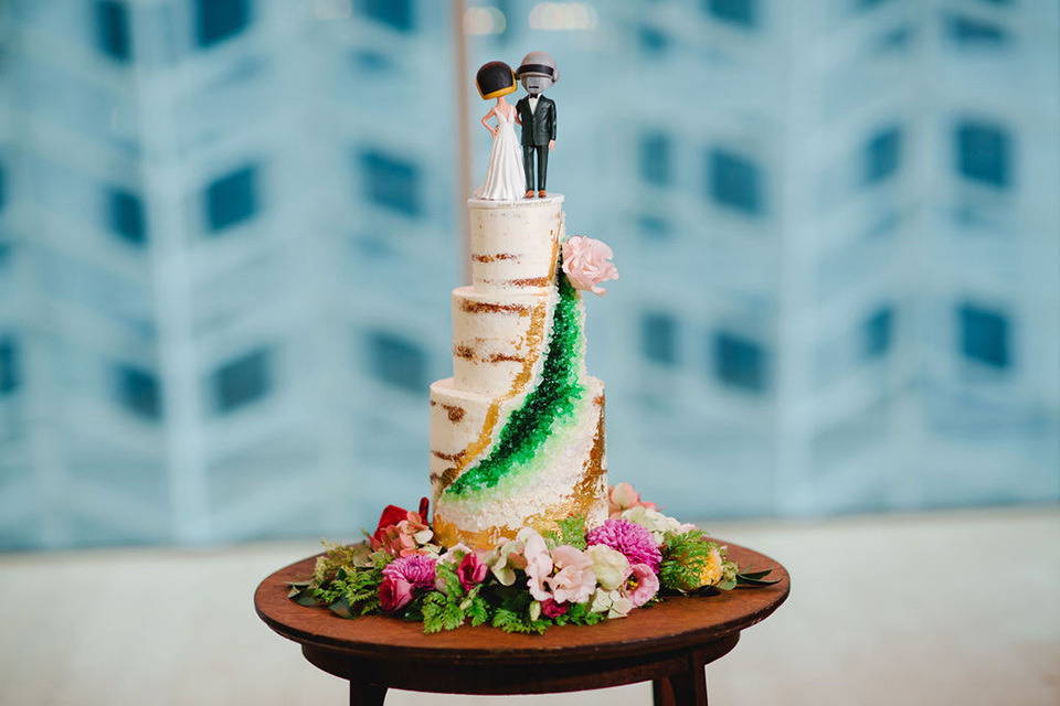  a downtown wedding at the cultural center with the groom and groomsmen in green suits and the bridesmaids in blush dresses and the bride in an a-line gown- a modern cake with green and pink décor and star wars cake topper