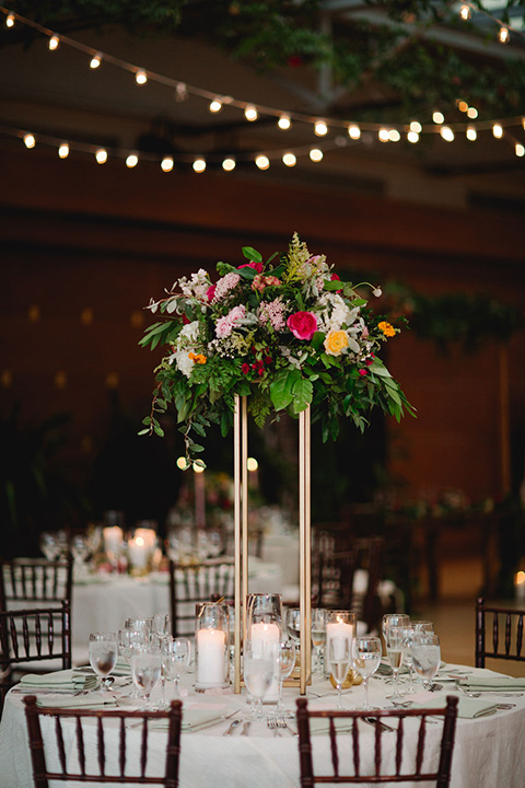  a downtown wedding at the cultural center with the groom and groomsmen in green suits and the bridesmaids in blush dresses and the bride in an a-line gown- reception tables 