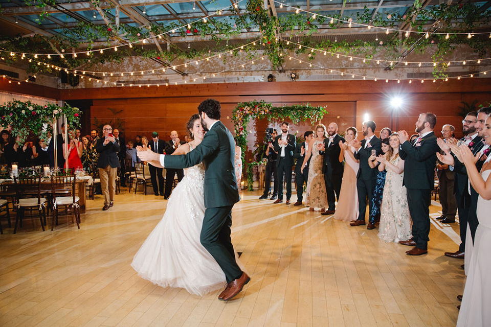  a downtown wedding at the cultural center with the groom and groomsmen in green suits and the bridesmaids in blush dresses and the bride in an a-line gown- couple during their first dance