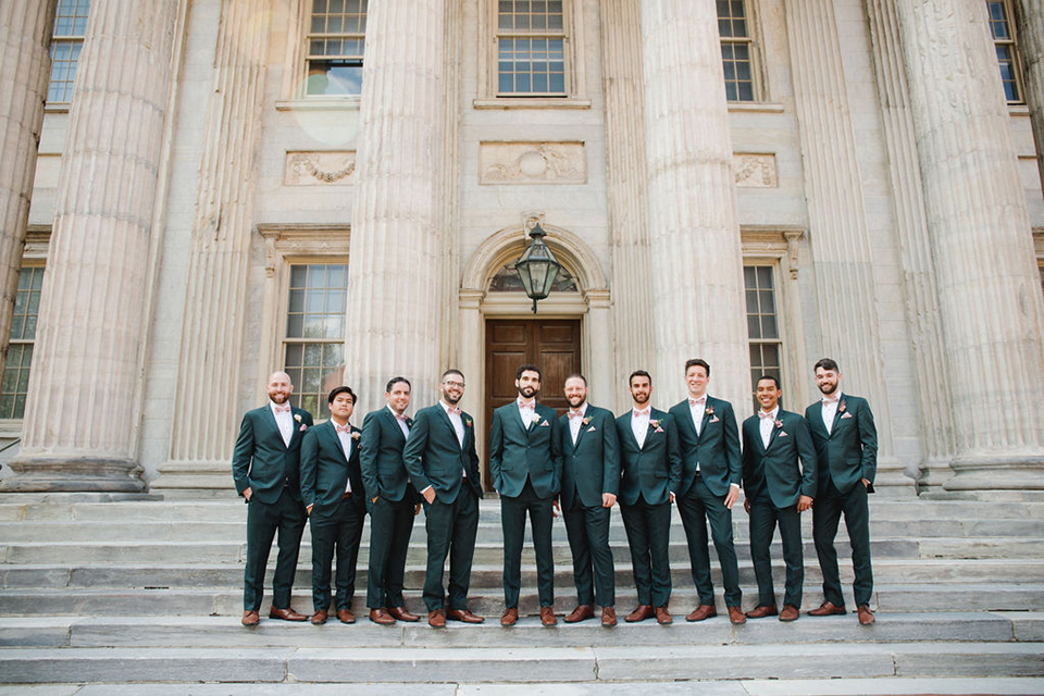  a downtown wedding at the cultural center with the groom and groomsmen in green suits and the bridesmaids in blush dresses and the bride in an a-line gown- groomsmen in a line