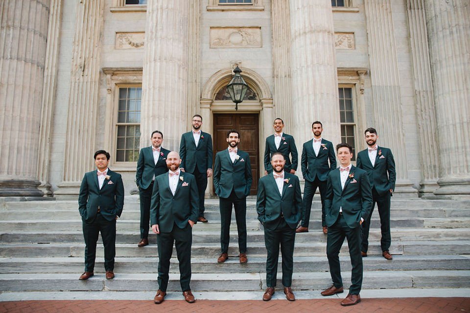  a downtown wedding at the cultural center with the groom and groomsmen in green suits and the bridesmaids in blush dresses and the bride in an a-line gown- groomsmen on the steps