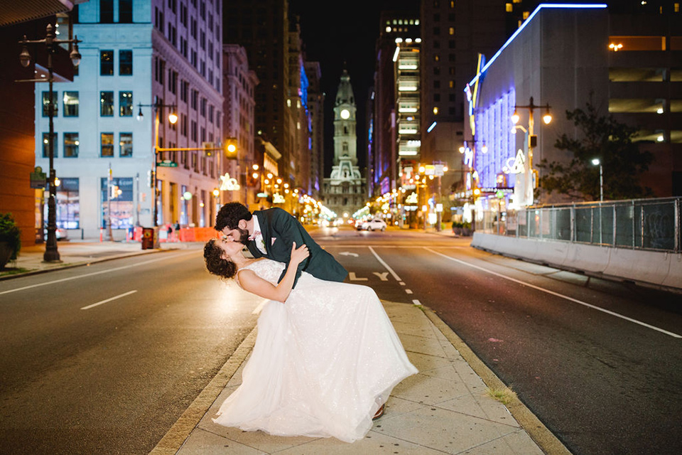  a downtown wedding at the cultural center with the groom and groomsmen in green suits and the bridesmaids in blush dresses and the bride in an a-line gown- couple kissing in the street