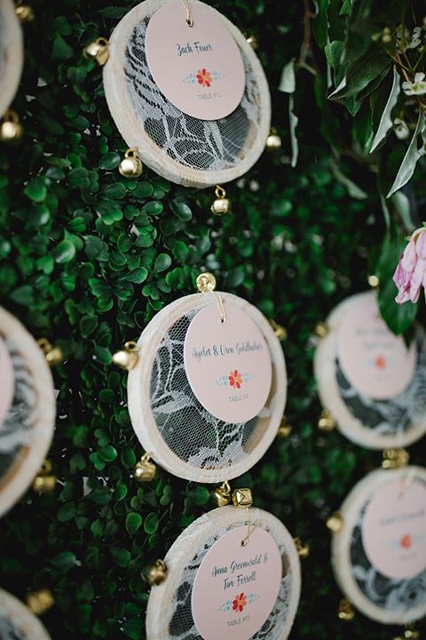  a downtown wedding at the cultural center with the groom and groomsmen in green suits and the bridesmaids in blush dresses and the bride in an a-line gown- seating chart close up 