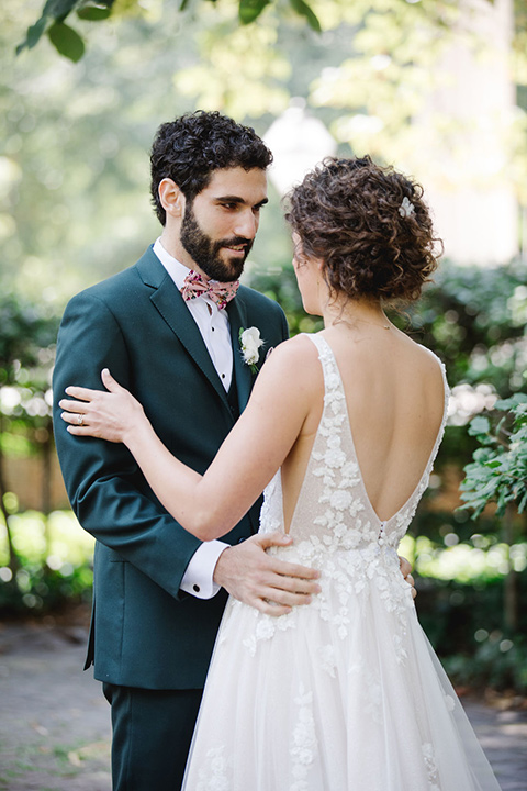  a downtown wedding at the cultural center with the groom and groomsmen in green suits and the bridesmaids in blush dresses and the bride in an a-line gown- couple walking outside the venue