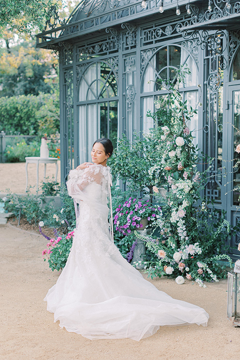  A French inspired wedding at a lavender farm with the bride in a fashion-forward white a-line gown with a high neckline and three dimensional floral appliques on it, the groom wore a light blue suit coat with a pair of tan pant and a grey velvet bow tie