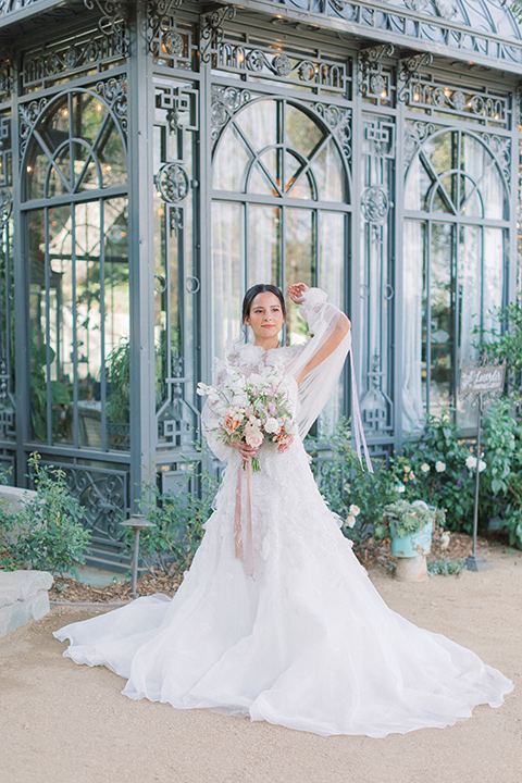  A French inspired wedding at a lavender farm with the bride in a fashion-forward white a-line gown with a high neckline and three dimensional floral appliques on it 
