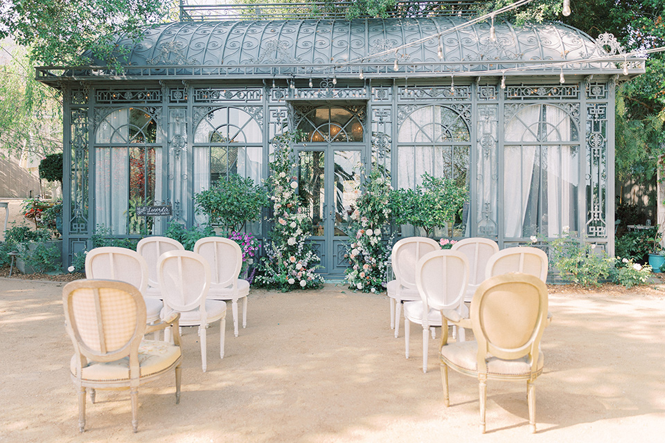 A French inspired wedding at a lavender farm – the ceremony was in front of a romantic greenhouse with cane chairs and green florals