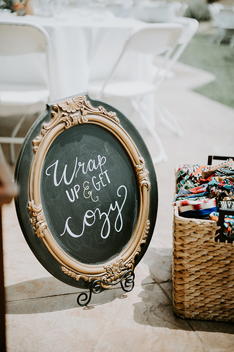  rustic boho wedding with warm colors and the bride in an off the shoulder gown and the groom in a caramel suit 