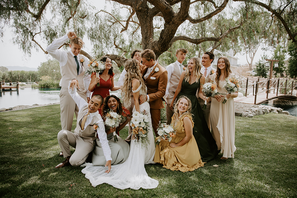  rustic boho wedding with warm colors and the bride in an off the shoulder gown and the groom in a caramel suit 