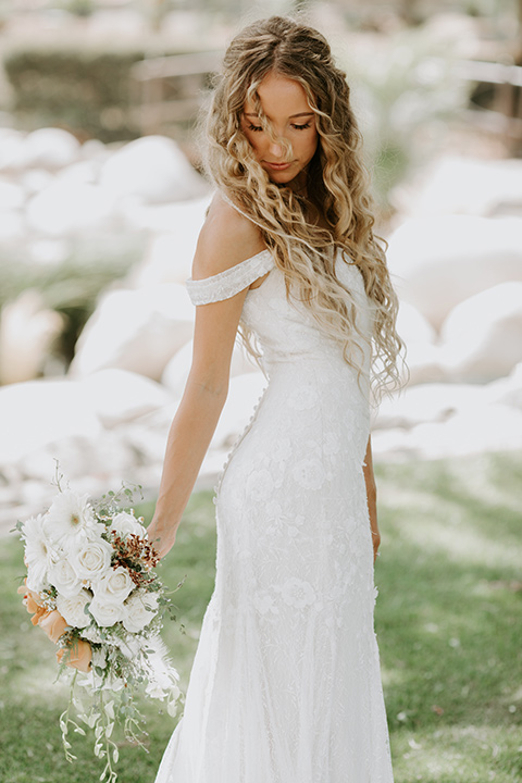  rustic boho wedding with warm colors and the bride in an off the shoulder gown and the groom in a caramel suit 