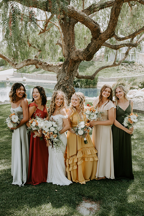  rustic boho wedding with warm colors and the bride in an off the shoulder gown and the groom in a caramel suit 