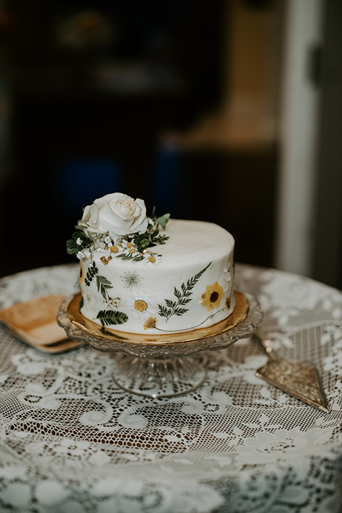  rustic boho wedding with warm colors and the bride in an off the shoulder gown and the groom in a caramel suit 