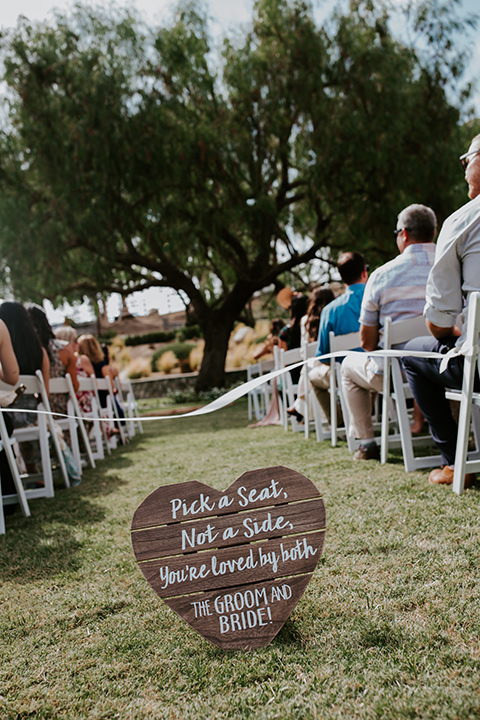  rustic boho wedding with warm colors and the bride in an off the shoulder gown and the groom in a caramel suit 