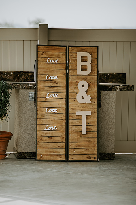  rustic boho wedding with warm colors and the bride in an off the shoulder gown and the groom in a caramel suit 