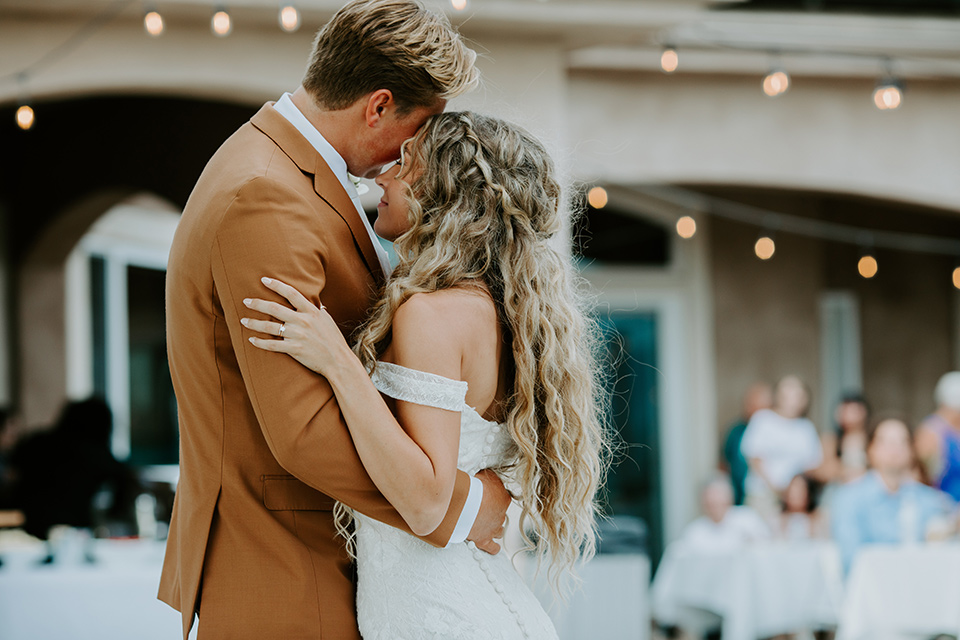  rustic boho wedding with warm colors and the bride in an off the shoulder gown and the groom in a caramel suit 