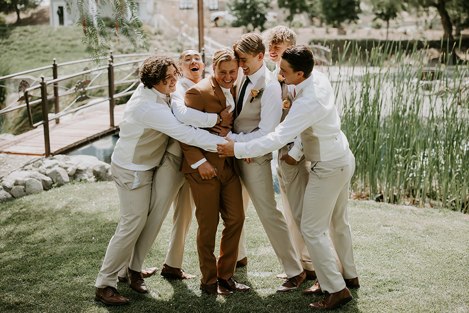  rustic boho wedding with warm colors and the bride in an off the shoulder gown and the groom in a caramel suit 