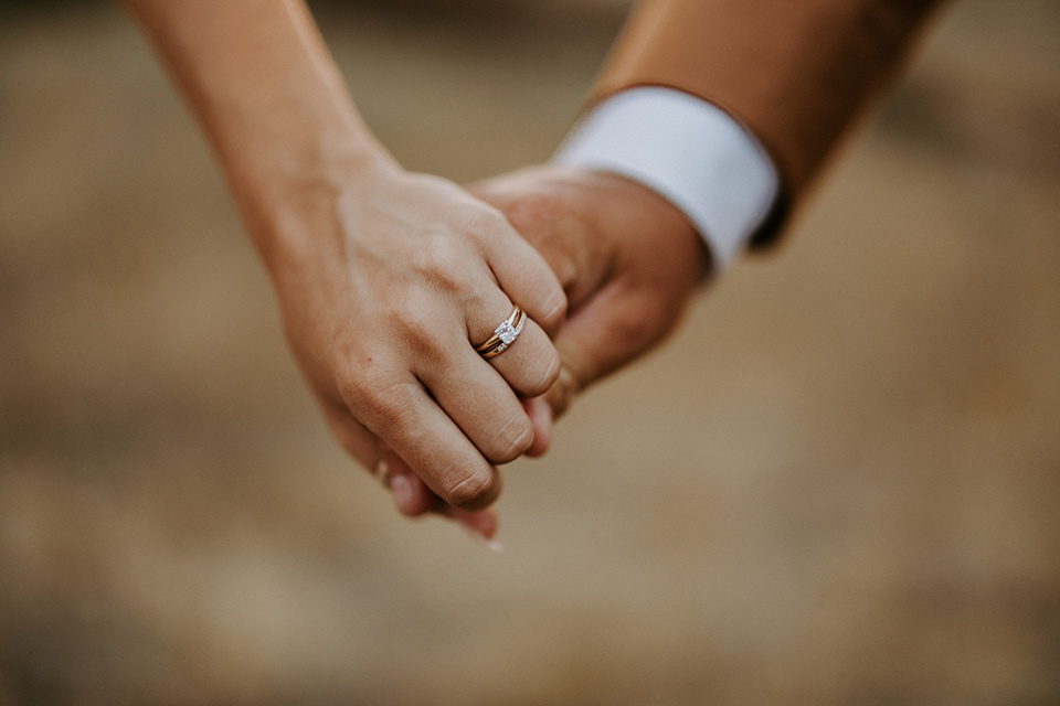  rustic boho wedding with warm colors and the bride in an off the shoulder gown and the groom in a caramel suit 