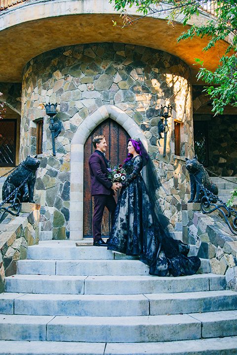  the nightmare before Christmas styled wedding with the bride in a black gown and the groom in a burgundy tuxedo 