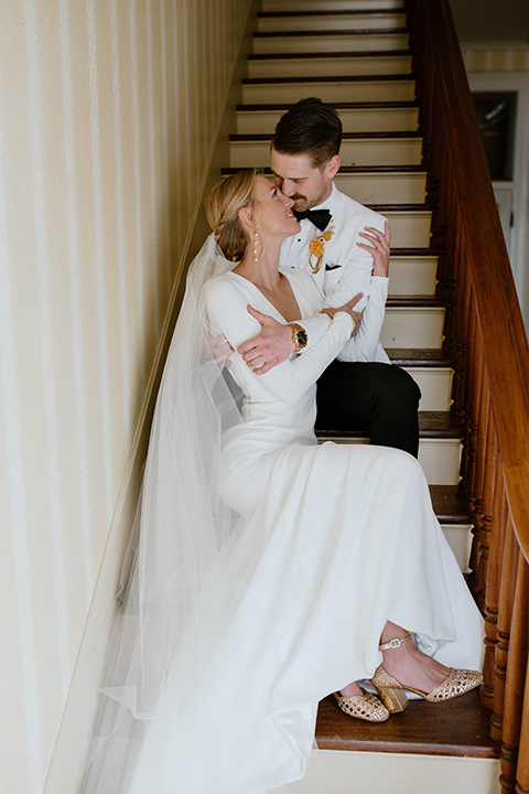  lizzie and tommys wedding on the beach with neutral colors and a gold velvet jacket – couple together