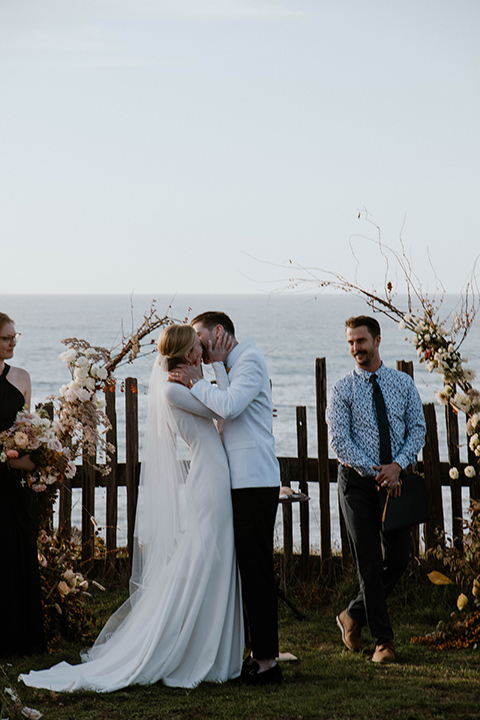  lizzie and tommys wedding on the beach with neutral colors and a gold velvet jacket – bride 