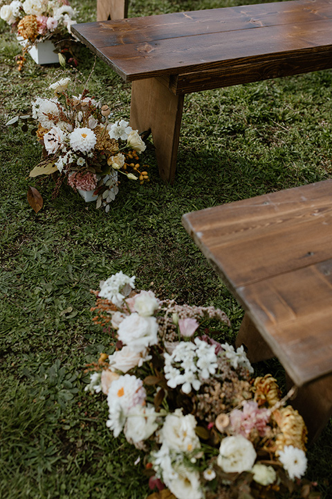  lizzie and tommys wedding on the beach with neutral colors and a gold velvet jacket – couple sitting