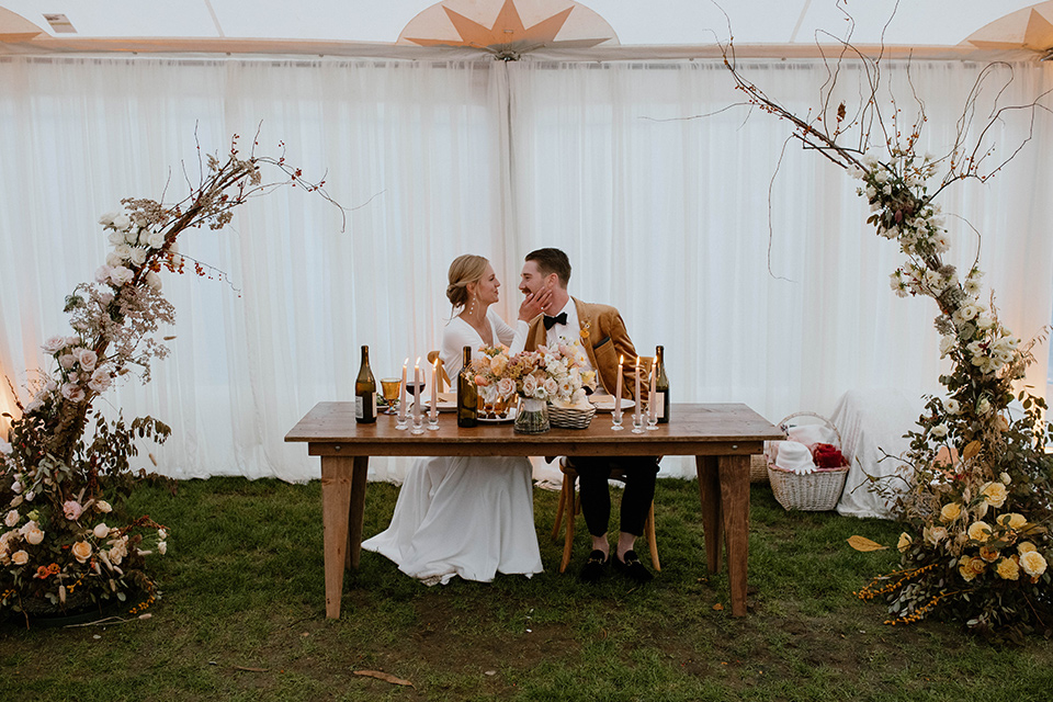  lizzie and tommys wedding on the beach with neutral colors and a gold velvet jacket – sweetheart tables