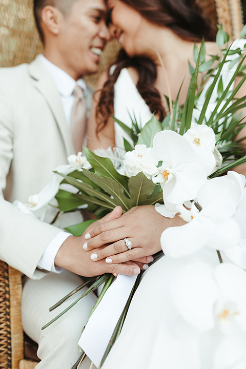  fun and tropical wedding inspired by Bali – bride and groom sitting in a chair  