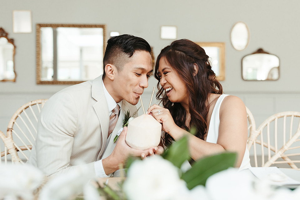  fun and tropical wedding inspired by Bali – couple sharing a coconut drink  