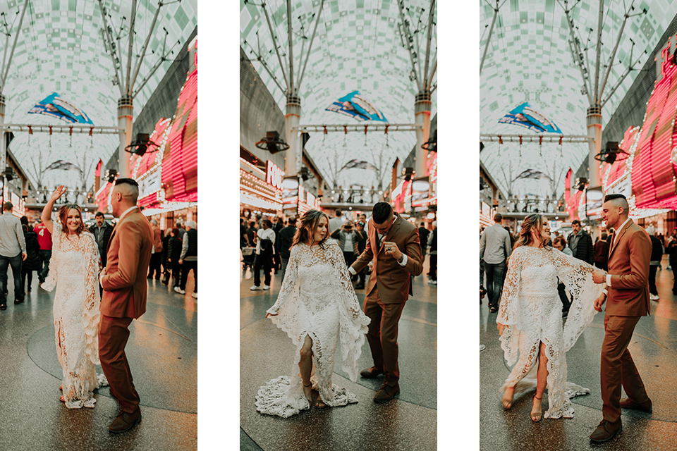  how to rent a suit or tuxedo in vegas a young couple wearing formal wear celebrating in the street on the Freemont Street Experience 