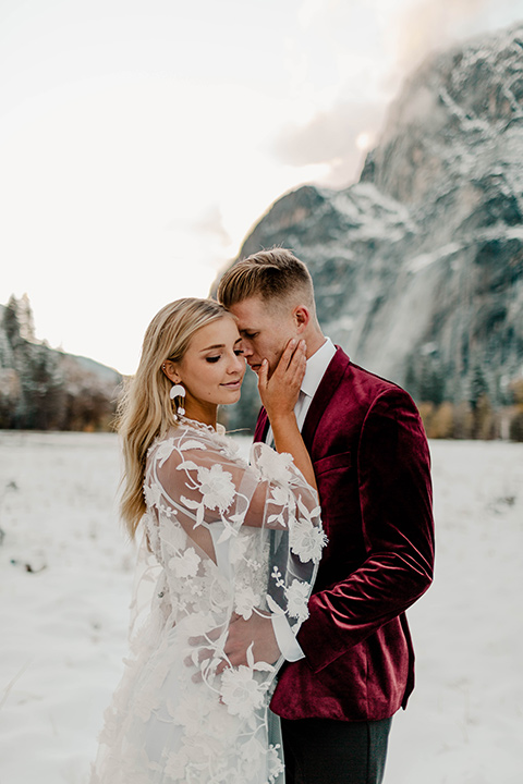  winter Yosemite wedding with the groom in a burgundy velvet tuxedo 